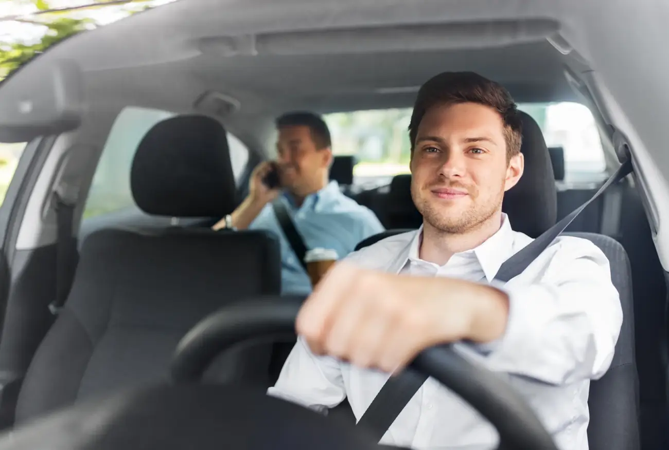 Driver and passenger belted in a commercial vehicle cabin during a working journey