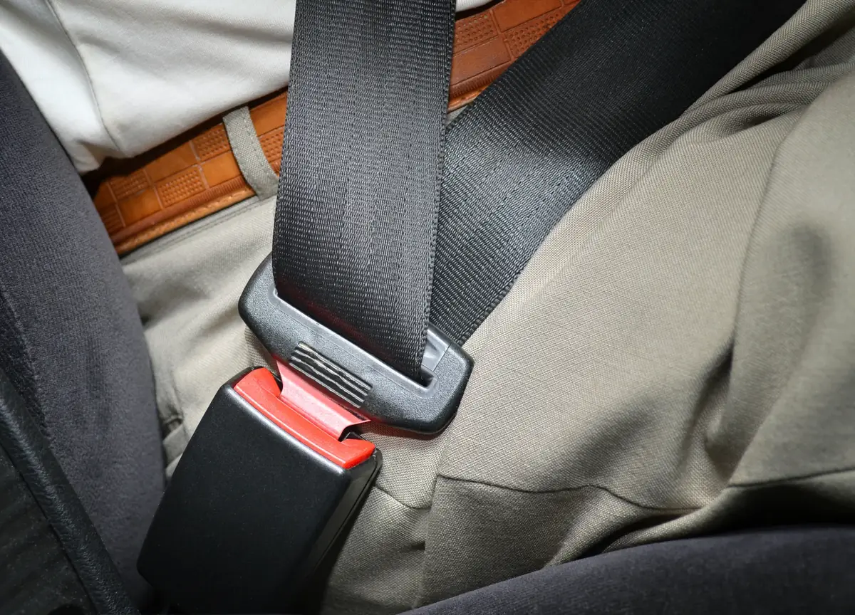 Seat belt fastened across an occupant seated inside a vehicle